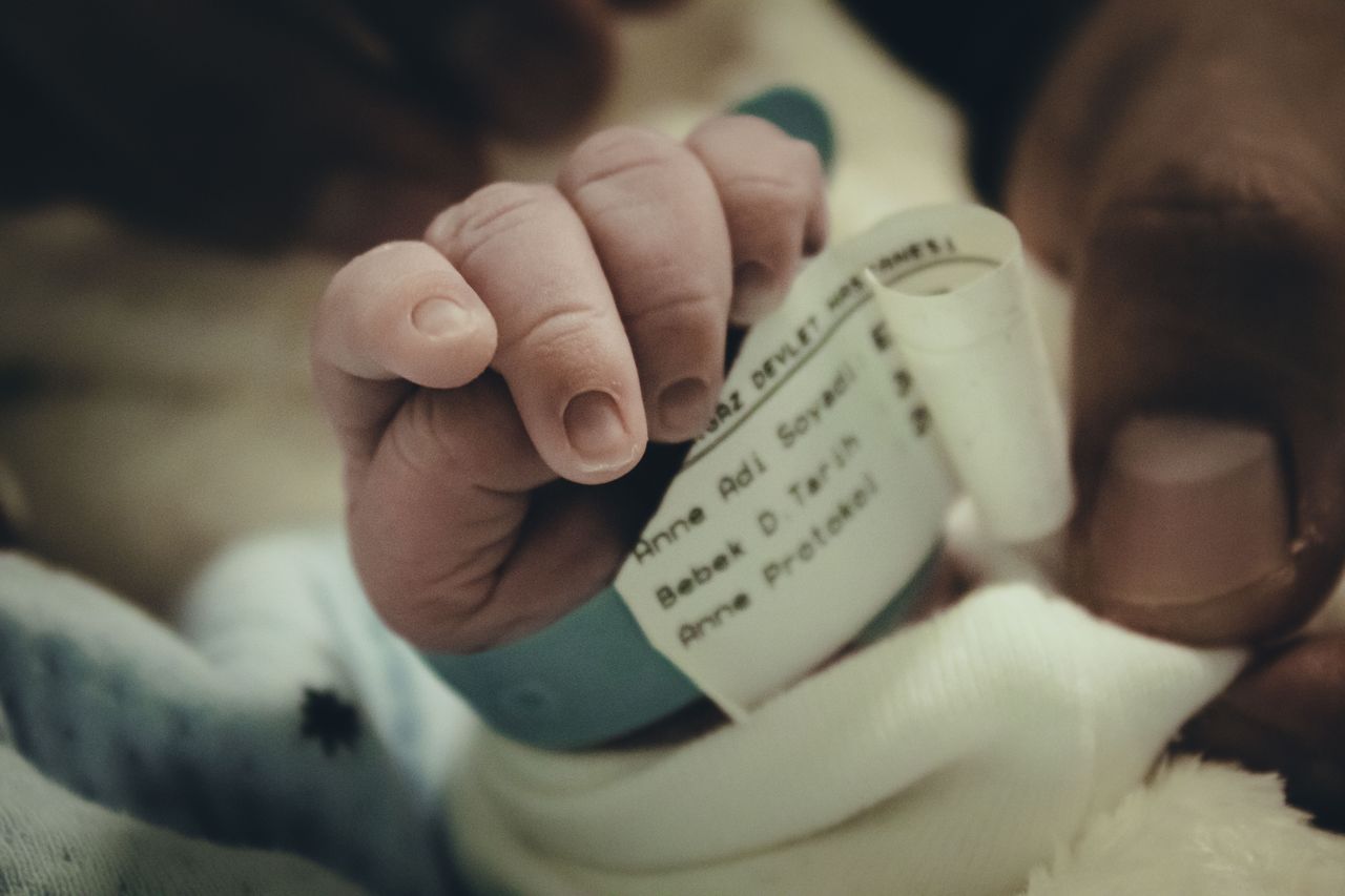Baby's hand with name tag