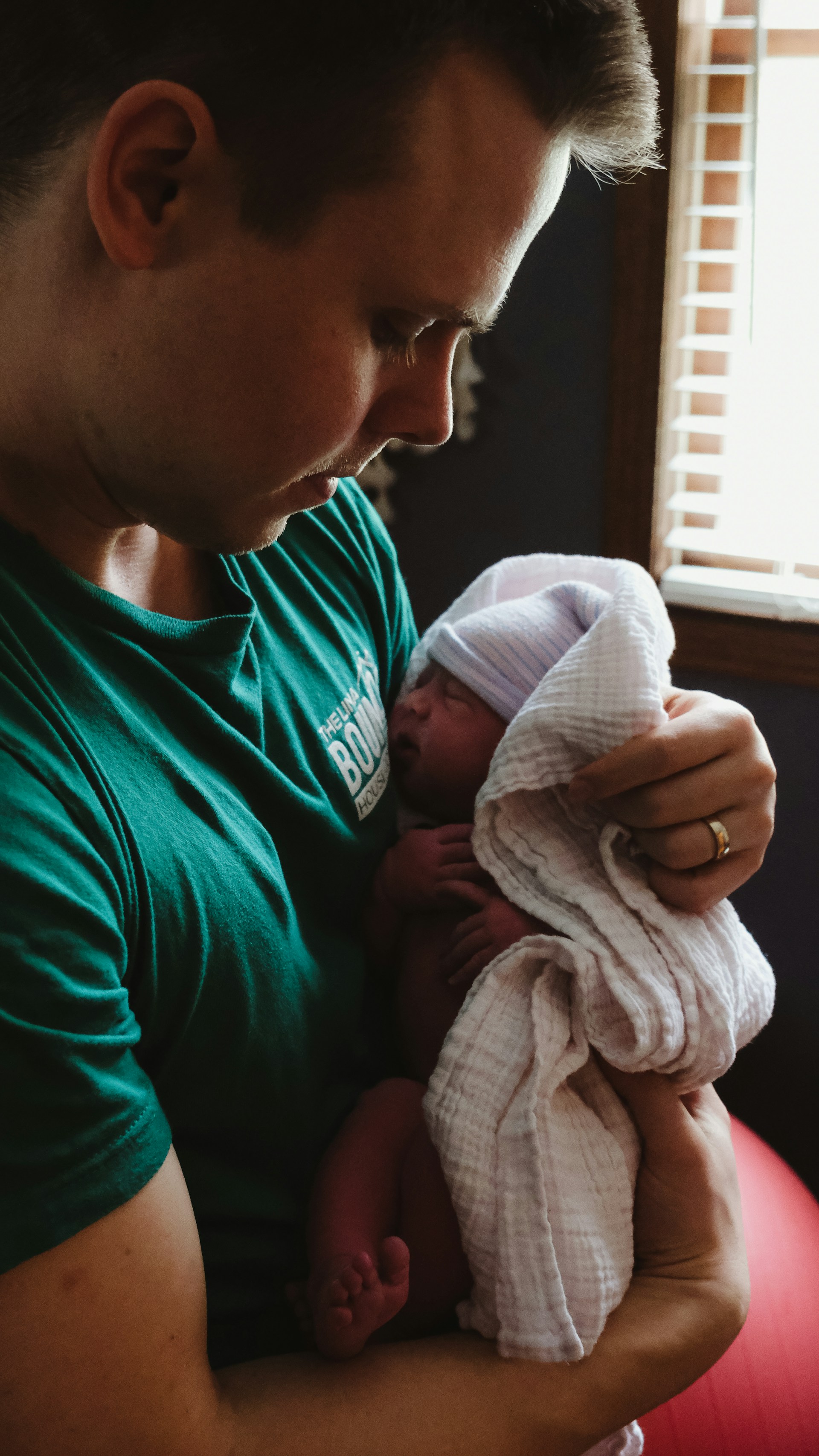 Father holding and bonding with a new born baby